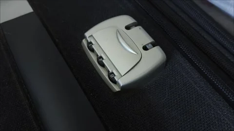 Close-up of a lock with a code on a black suitcase. Theft. Safety during travel. Stock Footage 313264373