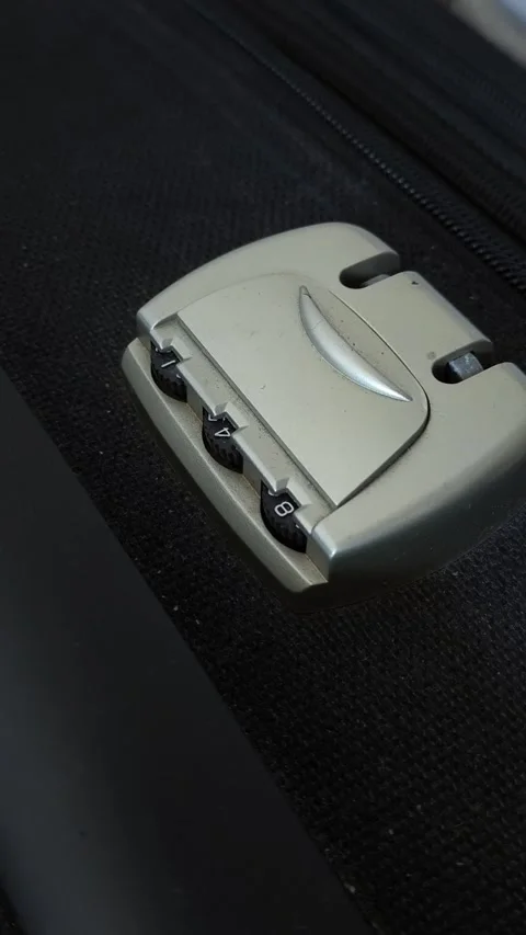 Close-up of a lock with a code on a black suitcase. Theft. Safety during travel. Stock Footage 313264561