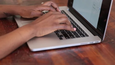 Close-up lockdown shot of hands of female blogger using laptop at table Stock Footage 114859635