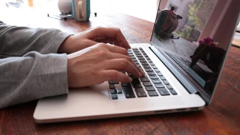 Close-up lockdown shot of hands of female blogger using laptop at table Stock Footage 114860115