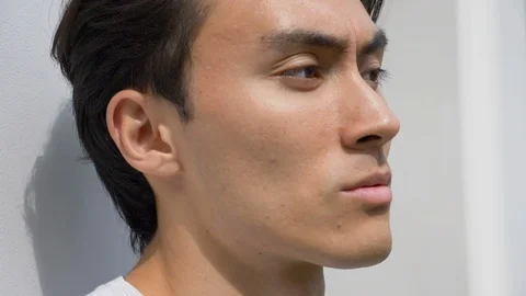 Close-up lockdown shot of handsome Asian man looking away Vídeo Stock 114874658