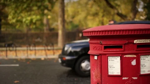 Close-up lockdown shot of red post box on the streets of city Video stock 114841749