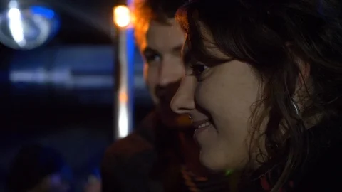 Close-up lockdown shot of two young people talking to each other at party Stock Footage 114874834