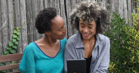 Close-up lockdown shot of two young women using tablet for video call Stock Footage 120062030