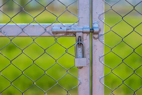 Close-up of locked metal gate with chain and latch Stock Photos
