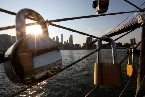 Close up locks of lovers hang on the bridge in the background the sea and the Stock Photos