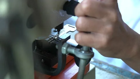 Close up of a locksmith creating a duplicate of a door lock Stock Footage 211577736