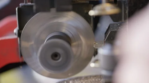 Close up of locksmith cutting a duplicate key with machinery in the workshop Stock Footage 102293097