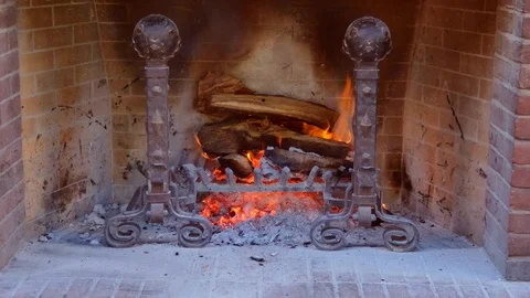 Close up of a log fire burning in a old style fireplace with a warm glow Stock Footage 102082014