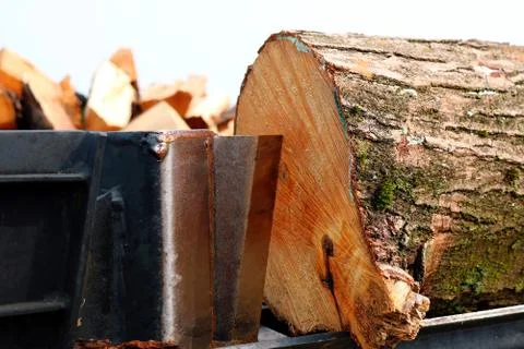 Close-up of log splitter and block of wood on platform Stock Photos