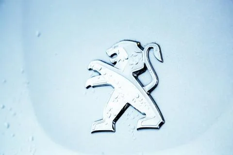 Close-up of the logo placed on the front bumper of the blue Peugeot SUV car Stock Photos