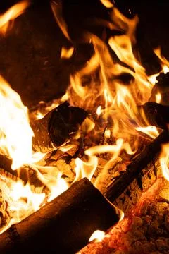 Close-up of Logs Burning with Intense Yellow and Orange Flames. Stock Photos