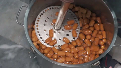 Close-up of Lokma balls being deep fried making traditional turkish sweet pastry Stock-Footage 227349423