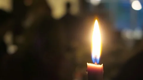 Close up of lone candle flame flickering at a party. Stock Footage 97381338