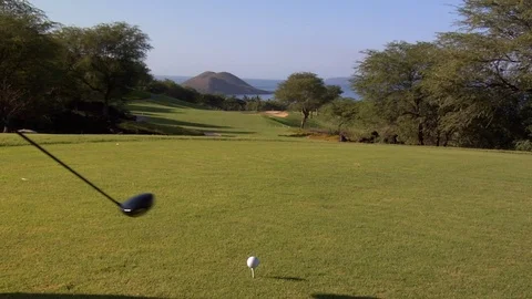 Close up of long drive golf hit off ball tee on island putting green Stock Footage 125339811