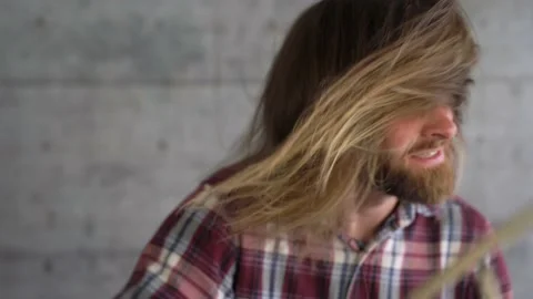 Close-up of long haired blond man is shaking hair planing drums active. Stock Footage 155554370