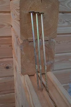 Close-up of long, threaded metal construction fasteners installed on a natura Stock Photos