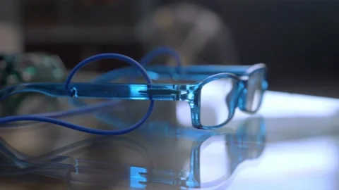A close up look at the blue glasses lying on the table Stock Footage 147937167