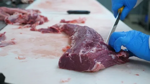 Close look of chef trimming fresh meat and removing unwanted fat Stock Footage 104930700