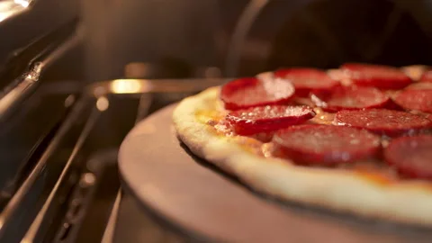 Close-up look of cooking a pepperoni pizza process in the oven in 4K. Stock Footage 137430752