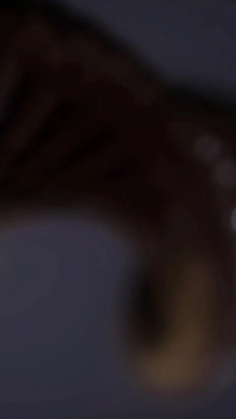 Close look at a detailed object showing texture and pattern in low light Stock Footage 336026989