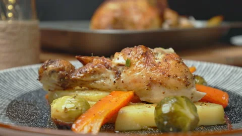 A close-up look of freshly roasted chicken with vegetables in a serving plate. Stock Footage 145118733