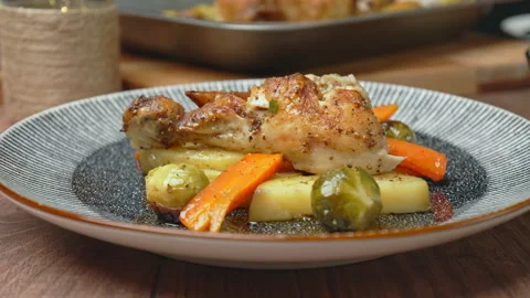 A close-up look of freshly roasted chicken with vegetables in a serving plate. Stock Footage 145118832