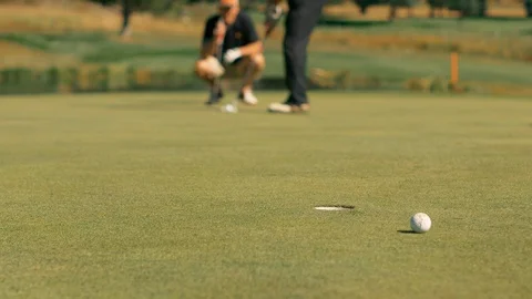 Close look of hole putt with 2 player Stock Footage 104299000