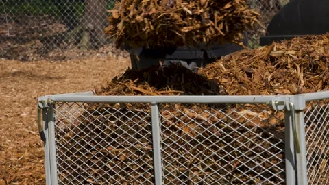 Close up look at a man scooping mulch out of a pull cart. Stock Footage 336466253