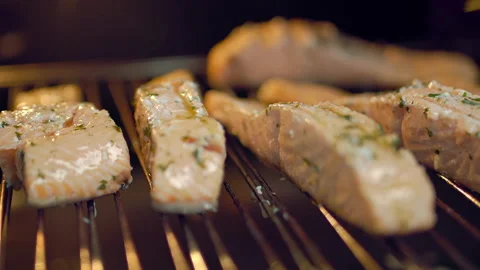 A close-up look of marinade sauce being brushed over fillets of salmon Stock Footage 132816248