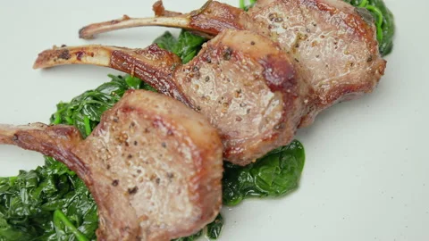 Close-up look to nicely cooked lamb ribs cutlets in a serving plate in 4K. Stock Footage 146001001