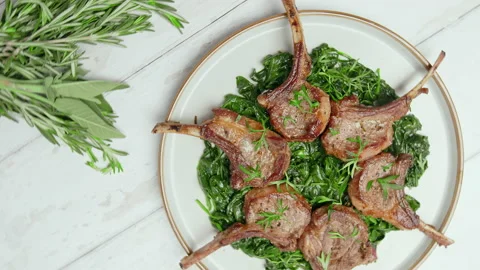 Close-up look to nicely cooked lamb ribs cutlets in a serving plate in 4K. Stock Footage 146001331