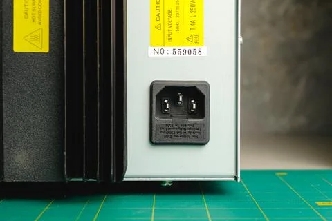 Close look at power supply connection on electronic device in workshop Stock Photos