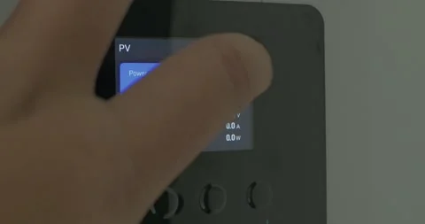 A close-up look at solar cell inverter digital screen showing real-time power Stock Footage 337785051