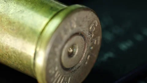 Close look at a spent bullet casing from a firearm in a detailed Stock Footage 328579605