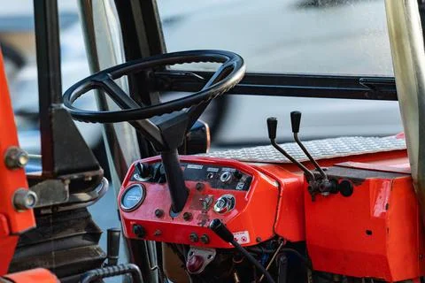 Close look at a tractor interior with controls and steering wheel Foto stock