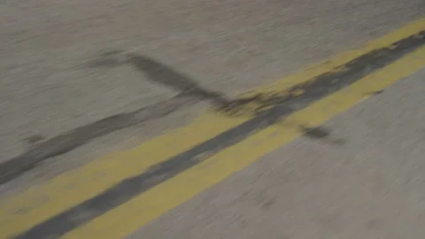 Close up looking down on double yellow line on asphalt paved road Stock Footage 221727169