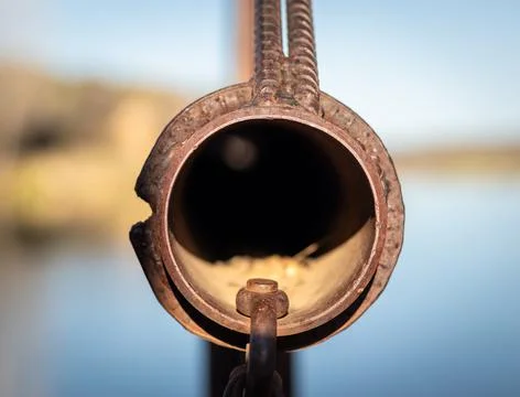 Close up looking down old mining equipment pipe with a blurry background, looks 스톡 사진