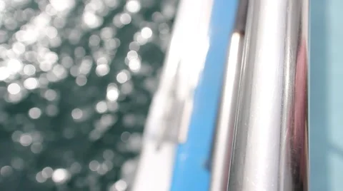 Close Up - Looking down off the side railing of a moving boat Stock Footage 2164729