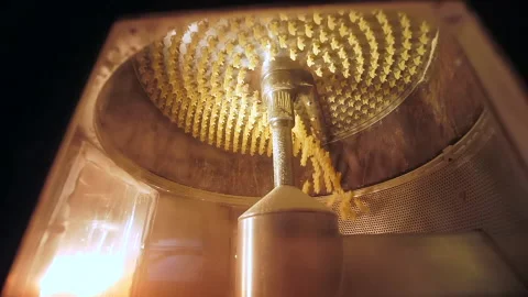 Close looking on the modern mechanism with rotating knife cuts raw macaronis Video stock 234050385
