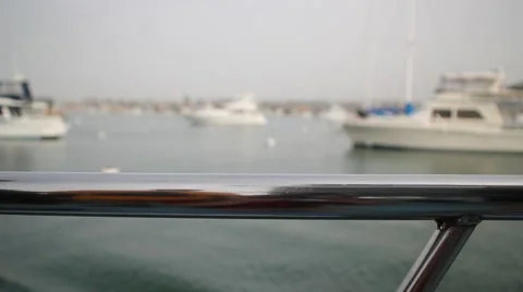 Close Up - Looking off the side railing of a moving boat Stock Footage 2165280