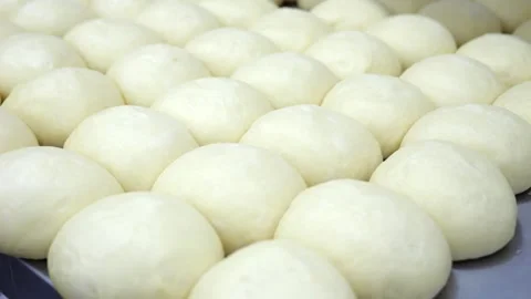 Close-up of a lot of burger buns covered with foil on a table in a kitchen. Stock Footage 339787659