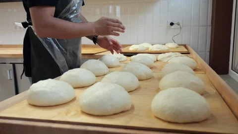 Close-up of a lot of burger buns covered with foil on a table in a kitchen. Stock Footage 341316638