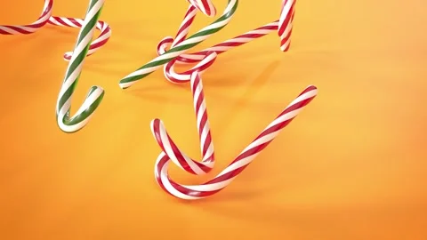 Close-up of a lot of red, green and white candy canes falling on a background Stock Footage 221240366