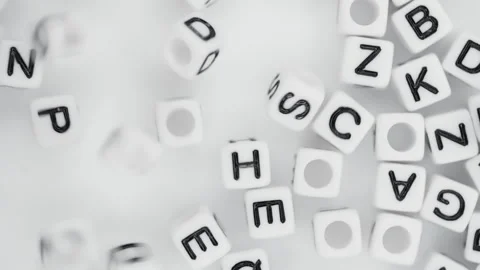 Close-up lot of white plastic cubes with alphabet letters falling down Stock Footage 265806361