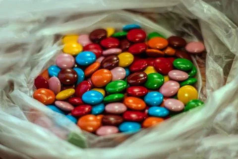 Close-up of lots of delicious multi-colored candies in a transparent plastic bag Stock Photos