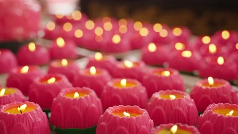 Close up lotus candle burning in row used for offering in buddhism event Stock Footage 231571561