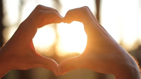Close up love shape of hands at sunset Video stock 86596406
