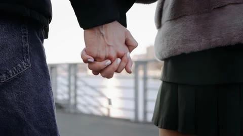 Close-up of lovers holding hands and walking forward Stock Footage 196242270