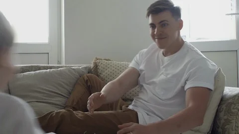 Close up of loving dad lifting cute small kid son play plane having fun on sofa Video stock 128350863